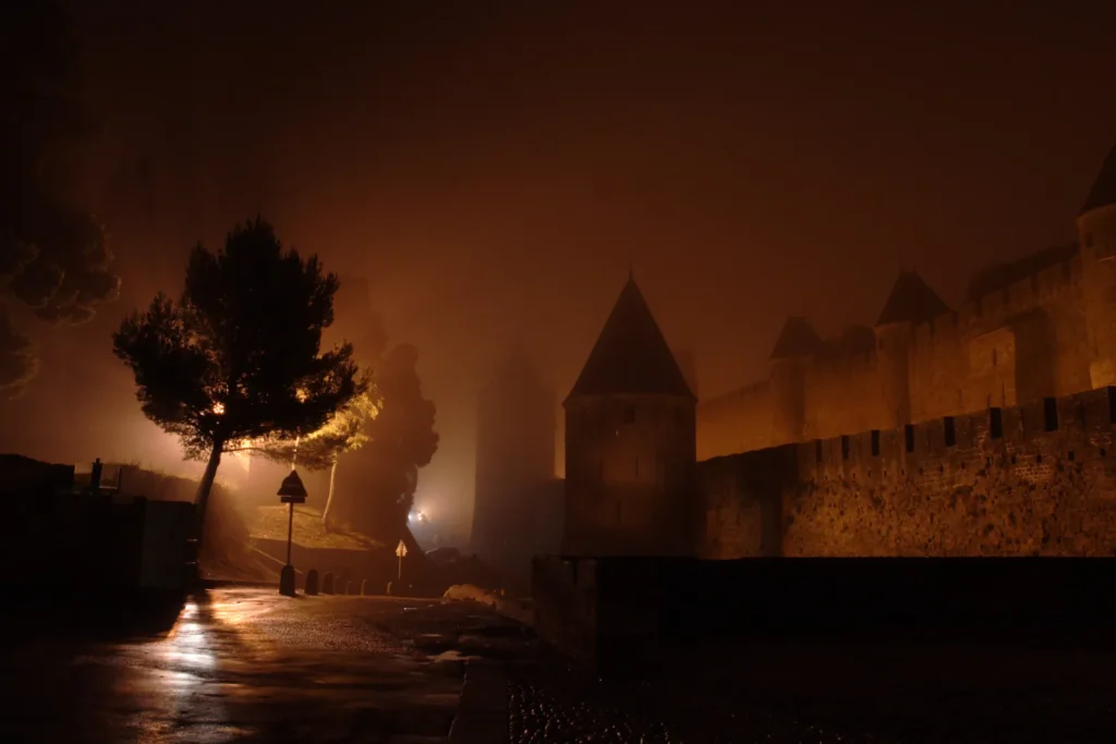 Remparts de Carcassonne dans la brume, de nuit, Occitanie